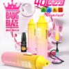An assortment of vaping devices including two colorful shisha products labeled "Bang Blaze" and "40000 Puffs," with a small black vape labeled "Mango Peach" and a multi-colored hookah, all set against a soft pink background with bubbles accentuating the theme.